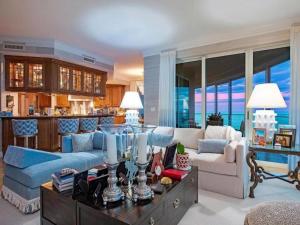 a living room with a couch and a table at Beachfront Elegance Escape in Naples