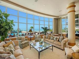 a large living room with a lot of windows at Beachfront Elegance Escape in Naples