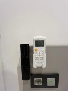 a calculator and a remote control on a wall at Mar De Pedra in Cangas de Morrazo