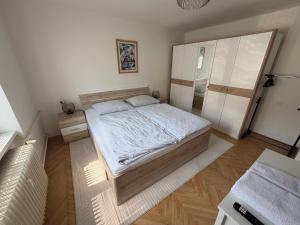 a bedroom with a large bed and a closet at Apartmán Hora in Muránska Huta