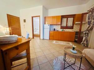 a room with a kitchen and a living room at Alexandra's House in Skiathos