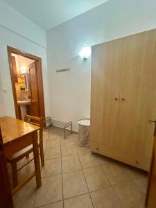 a room with a table and a large cabinet at Alexandra's House in Skiathos +44 photos
