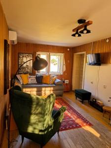 a living room with a couch and a chair at Simina kuća in Bajina Bašta