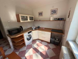 a small kitchen with a washing machine in it at Apartmán Hora in Muránska Huta