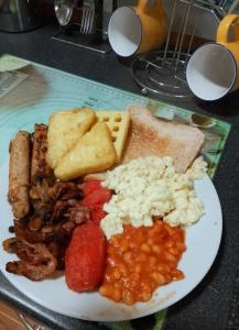 a plate of food with meat beans and bread at Avalon B&B Scarborough in Scarborough