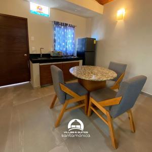 a kitchen with a table and chairs in a room at Villas & Suites Santa Monica in Rincon de Guayabitos +11 photos
