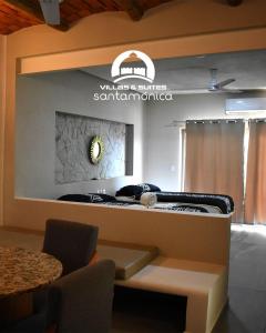 a room with a table and a sign on the wall at Villas & Suites Santa Monica in Rincon de Guayabitos