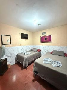 a room with two beds and a flat screen tv at Cristales de Antigua La Calzada in Antigua Guatemala +50 photos