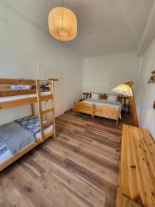 a room with two bunk beds and a table at Holiday Home up to 7 Guests in Fürstenfeld