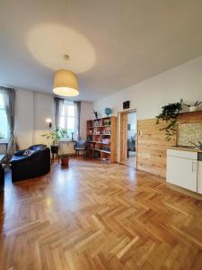 a living room with a wooden floor and a couch at Holiday Home up to 7 Guests in Fürstenfeld