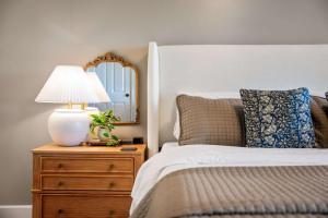 a bedroom with a bed with a lamp and a mirror at Historic Riverview Inn Six in Chattanooga