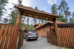 a car parked in a parking lot in front of a house at Forest soul "Jaslice" - Ozren in Doboj