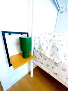 a small bedroom with a bed and a mirror at Casa Cachú in Baiona