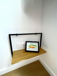 a picture frame sitting on a shelf in a room at Casa Cachú in Baiona