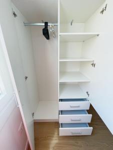 a walk in closet with white shelves at Casa Cachú in Baiona
