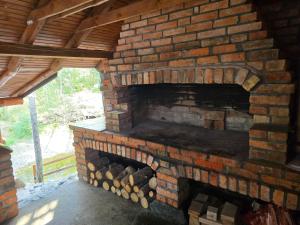a brick oven with a pile of fire wood at Forest soul "Jaslice" - Ozren in Doboj