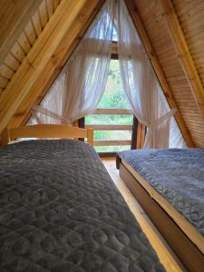 a bedroom with a bed and a window at Forest soul "Jaslice" - Ozren in Doboj