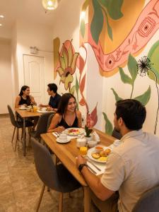 a group of people sitting at tables in a restaurant at Hotel Altara AQP in Arequipa