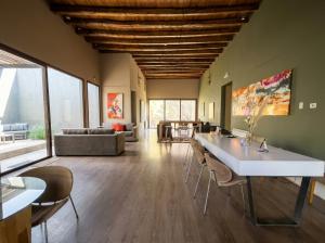 a living room with a large white table and chairs at Posada del Blanco in Potrerillos