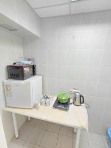a kitchen with a table with a microwave on it at Tik-Tak Mini-Hotel in Cherkasy +11 photos