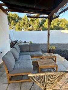 a couch and coffee tables on a patio at VillaMar in Villaverde