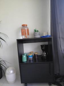 a black shelf with a coffee maker on it at Villa Terraza in El Castillo de La Fortuna +9 photos