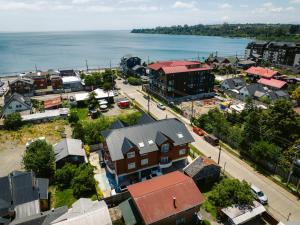 an aerial view of a town with the water at Studios y Departamentos Nómades del Lago in Puerto Varas