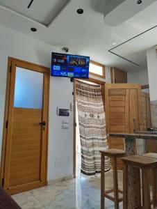 a room with a door and a television on the wall at 1-bedroom apartment in Monastir