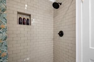 a bathroom with three bottles of wine in a shower at Historic Riverview Inn Seven in Chattanooga