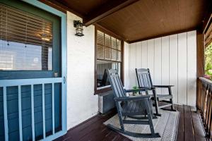 two chairs sitting on the porch of a house at Historic Riverview Inn Seven in Chattanooga