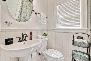 a bathroom with a sink and a toilet and a mirror at Historic Riverview Inn Seven in Chattanooga