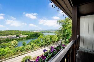 a balcony with flowers and a view of a river at Historic Riverview Inn Seven in Chattanooga +23 photos