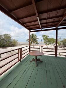 a wooden deck with a table on the beach at casa sol in Bragança