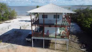 a house with a balcony on the beach at casa sol in Bragança +4 photos