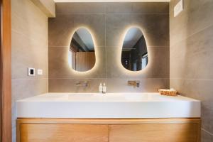 a bathroom with a sink and two mirrors at Vila das Acácias - Boutique Villa in Wine Country in Alenquer +103 photos