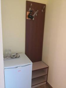 a refrigerator with a picture of a guitar on the wall at Свети Кирил Лозенец in Lozenets