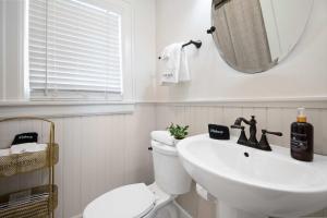a bathroom with a sink and a toilet and a mirror at Historic Riverview Inn Eight in Chattanooga