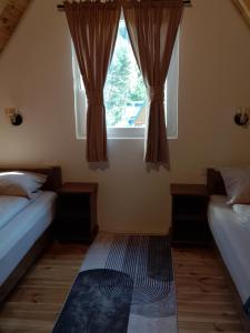 a bedroom with two beds and a window at House Vasilije in Žabljak