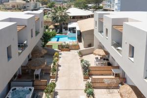 an aerial view of a building with a swimming pool at Nikolas Apartments in Amoudara Herakliou