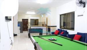 a living room with a pool table in it at Albaraka-farm in Az Zarqa