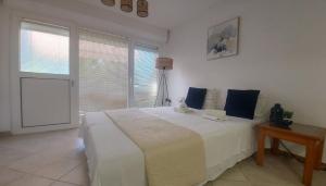 a bedroom with a large white bed and a window at Jadran5 in Petrovac na Moru