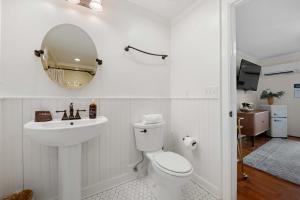 a bathroom with a toilet and a sink and a mirror at Historic Riverview Inn Suite Ten in Chattanooga
