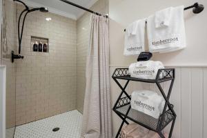 a bathroom with a shower with towels and a shower curtain at Historic Riverview Inn Suite Ten in Chattanooga