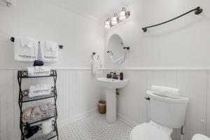 a white bathroom with a toilet and a sink at Historic Riverview Inn Suite Ten in Chattanooga