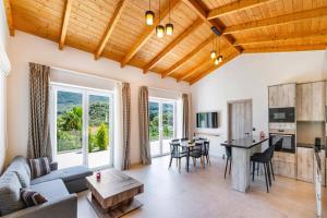a living room with a couch and a table at Villa Mario by Villa Plus in Katokhórion