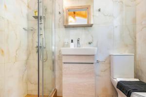 a bathroom with a sink and a shower at Villa Mario by Villa Plus in Katokhórion +14 photos
