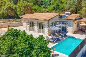 an aerial view of a house with a swimming pool at Villa Mario by Villa Plus in Katokhórion