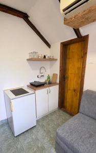 a small kitchen with a sink and a table at Safari Luštica in Luštica +8 photos