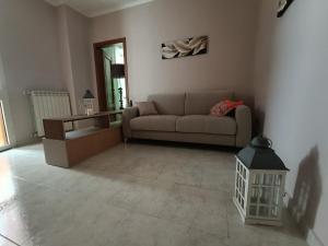 a living room with a couch and a table at La terrazza sul fiume in Spoleto +2 photos
