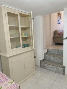 a white cabinet in a room with a staircase at La terrazza sul fiume in Spoleto